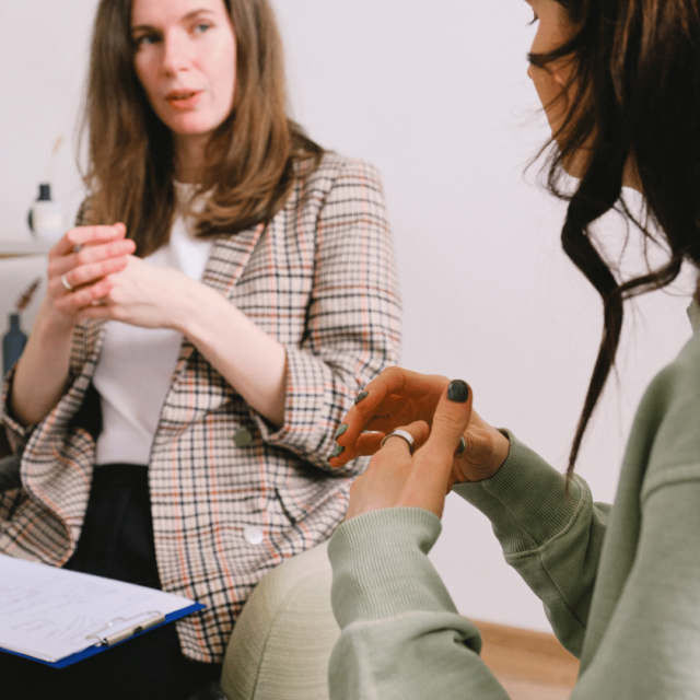 Two women talk during their employee coaching session